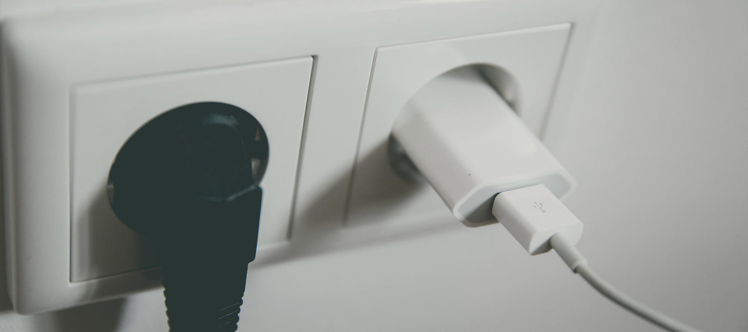 Two plugs in white wall outlets